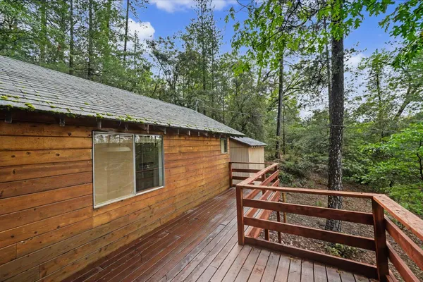 a view of outdoor space with deck and trees