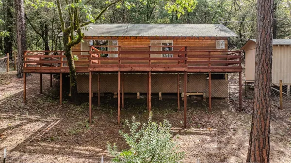 a view of a chairs and table in the backyard
