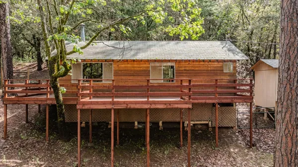 a view of a house with a tree