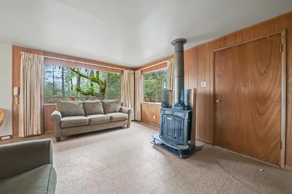 a living room with furniture and a floor to ceiling window