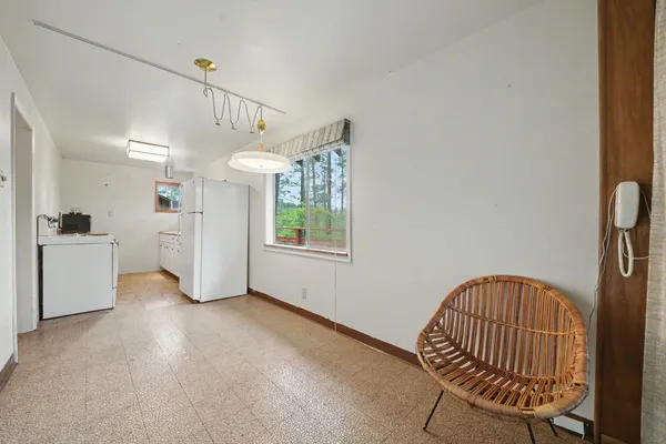 a view of a hallway with entryway and workspace