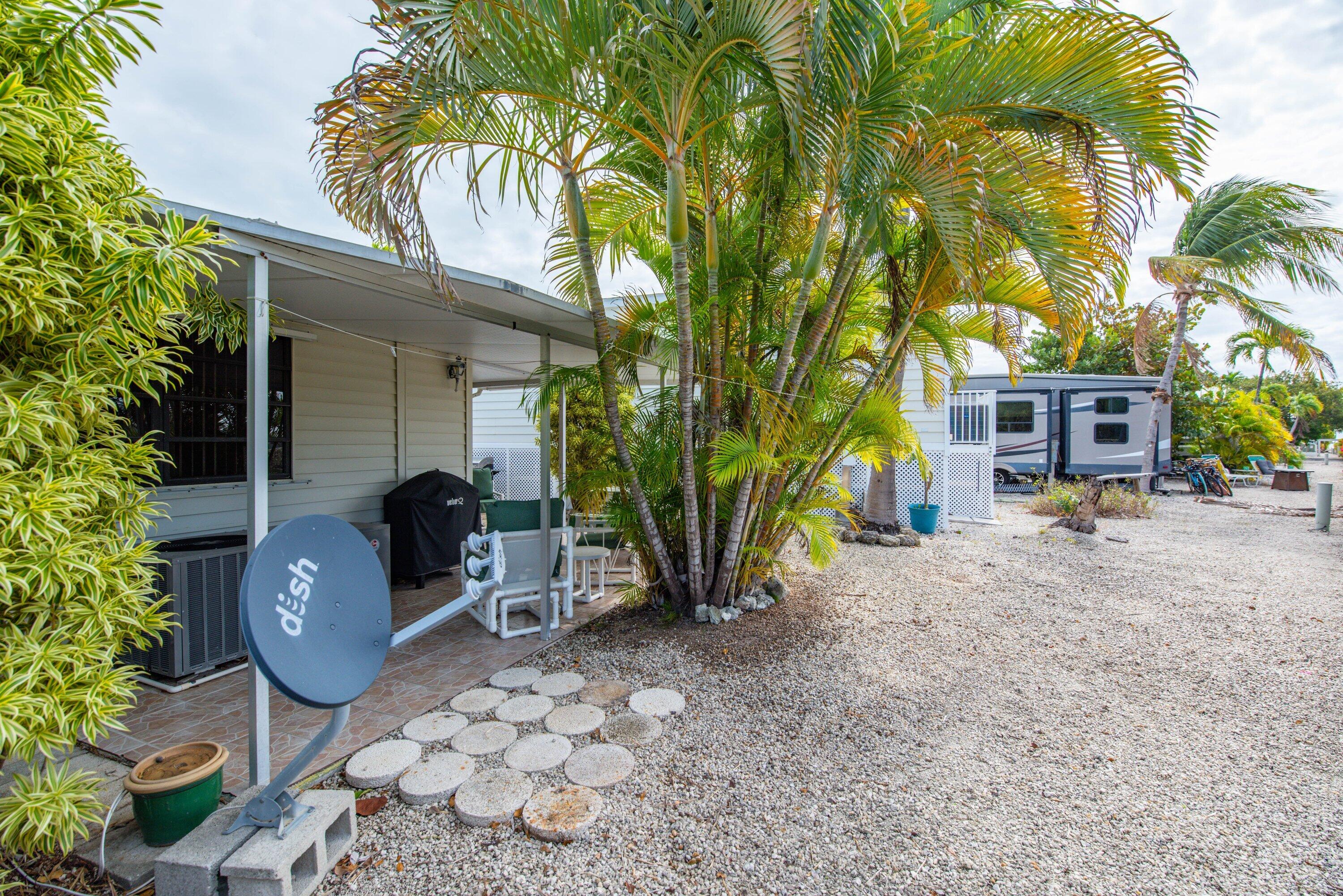 701 Spanish Main Drive, Unit 21 Cudjoe, FL 33042 - Photo 22 of 49 a view of a chairs and table in the backyard