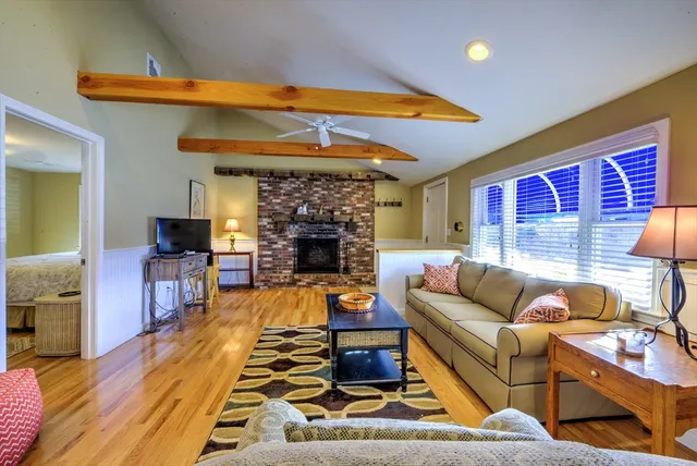 a bedroom with a bed and a mirror on dresser