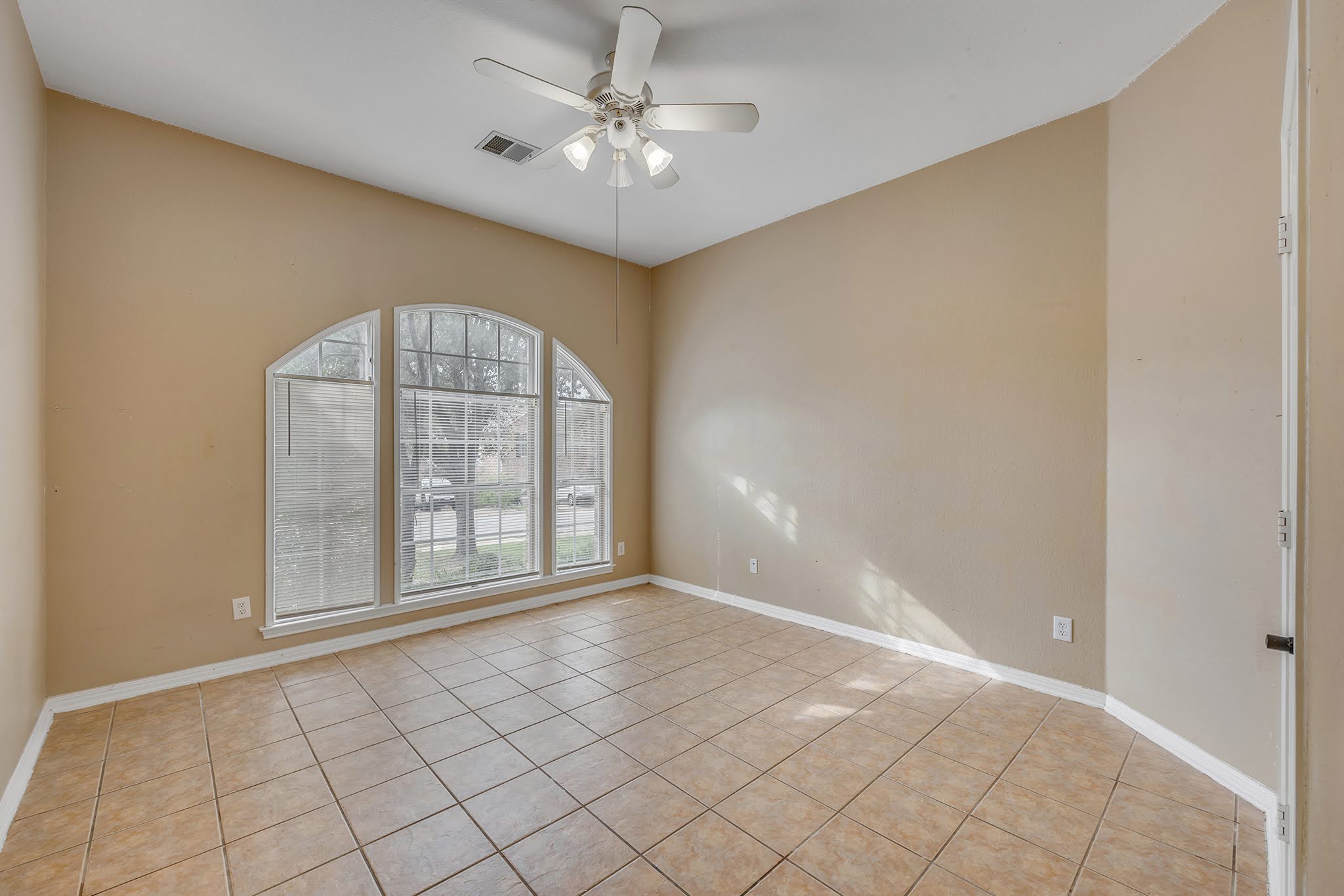 2726 Grimes Ranch Road Austin, TX 78732 - Photo 8 of 35 Empty room featuring light tile patterned floors and ceiling fan