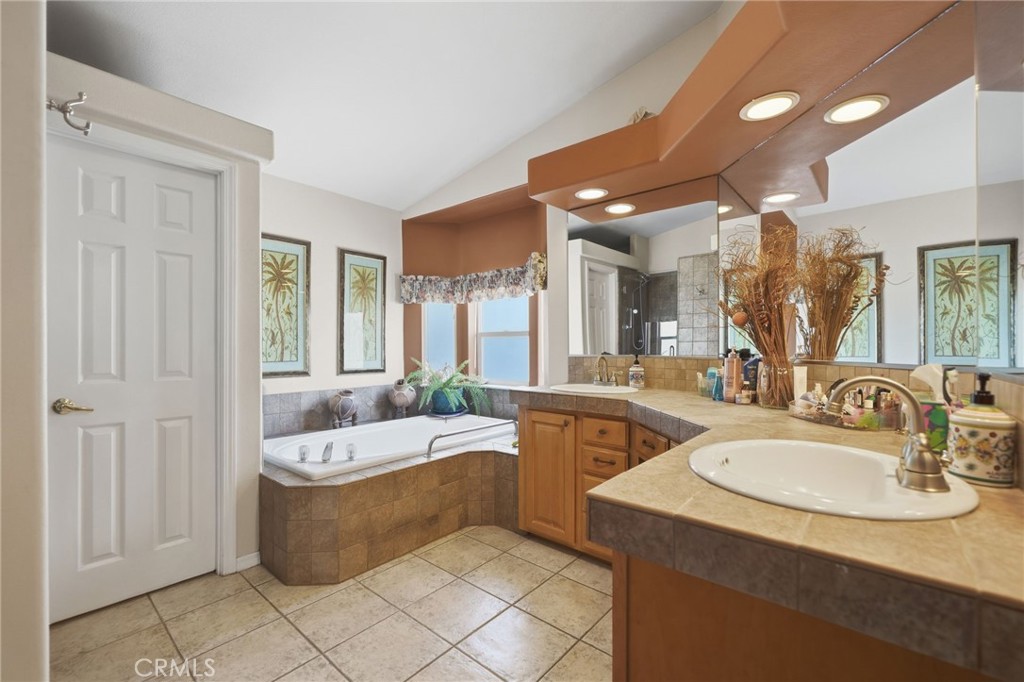 35780 Greer Road Murrieta, CA 92562 - Photo 31 of 56 Primary bathroom w dual sinks, stone tile countertops and separate tub and shower