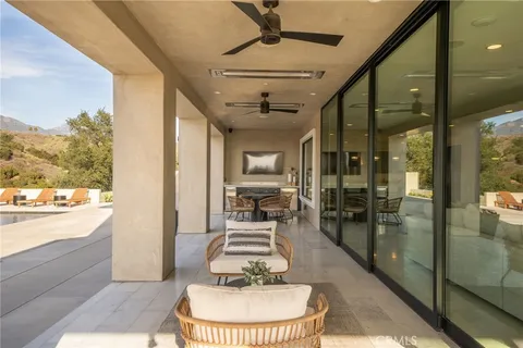 a view of a white house with a big yard and large trees