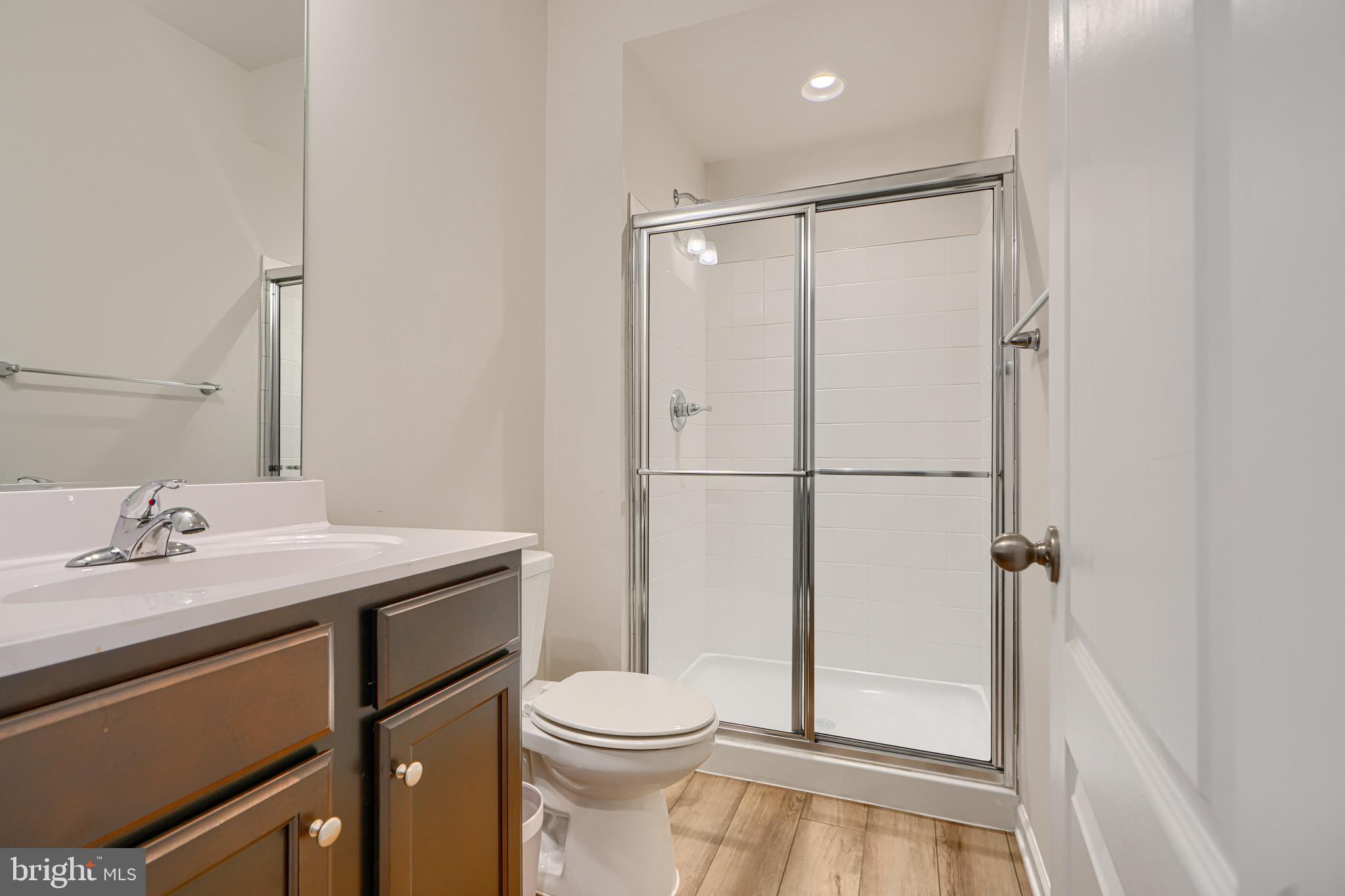 1324 Ricketts Road Frederick, MD 21702 - Photo 6 of 49 a bathroom with a granite countertop sink toilet a mirror and shower