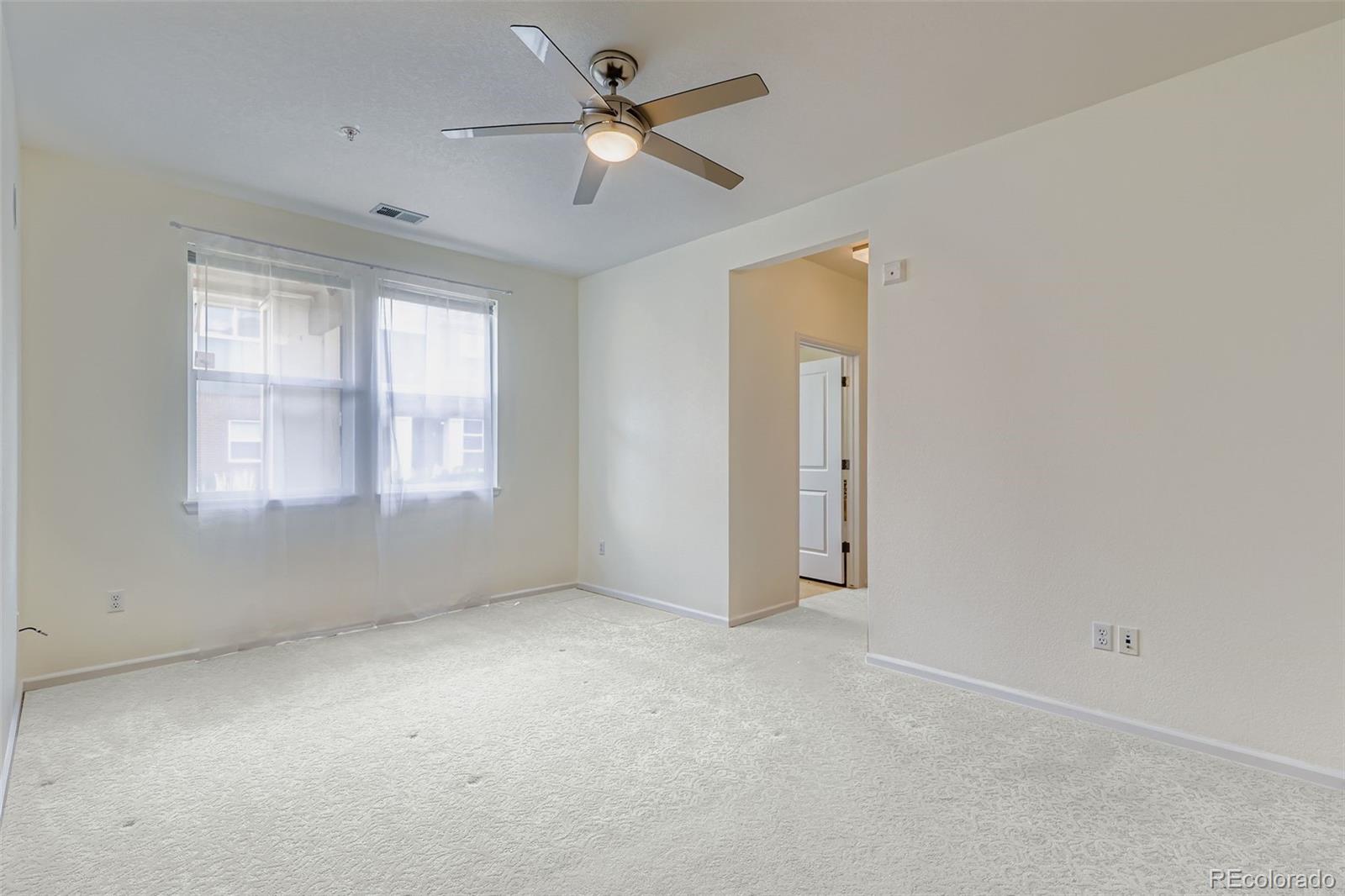11316 Colony Circle Broomfield, CO 80021 - Photo 7 of 20 an empty room with windows and fan