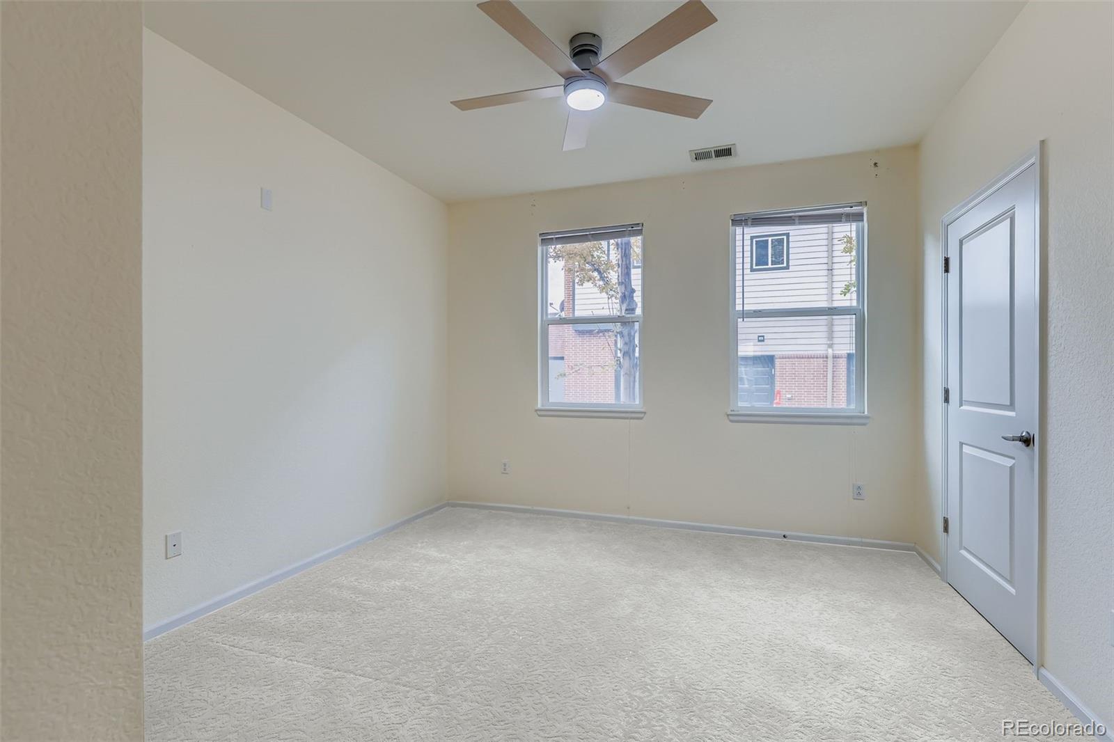 11316 Colony Circle Broomfield, CO 80021 - Photo 10 of 20 an empty room with windows and fan