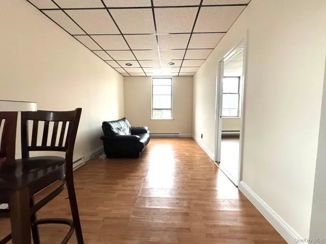 a view of a livingroom with furniture window and wooden floor