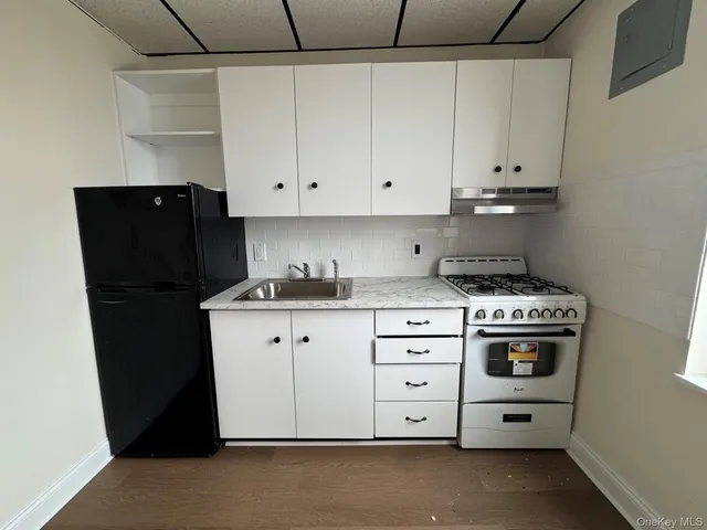 a kitchen with cabinets and appliances
