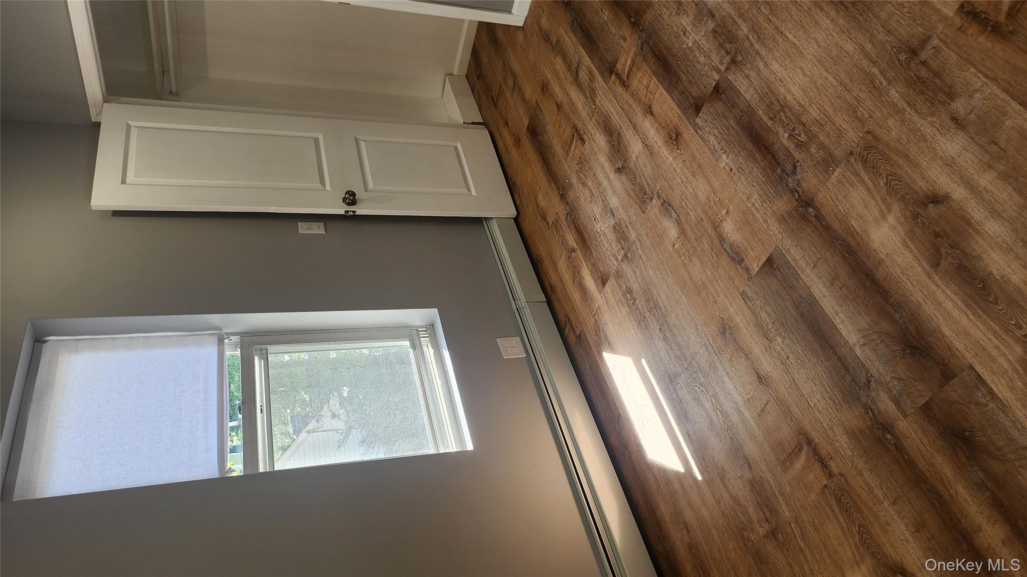 38 Moulton Avenue, Unit 2 Dobbs Ferry, NY 10522 - Photo 20 of 27 a view of an empty room with wooden floor and a window