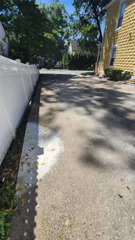a view of a house with a yard and large tree