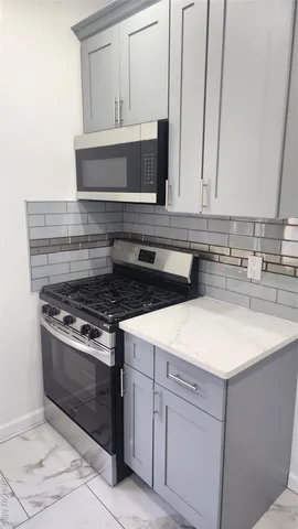 a stove top oven sitting inside of a kitchen