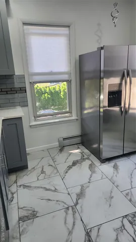 a kitchen with a refrigerator and a stove