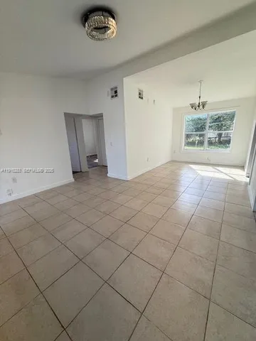 a view of an empty room and a window