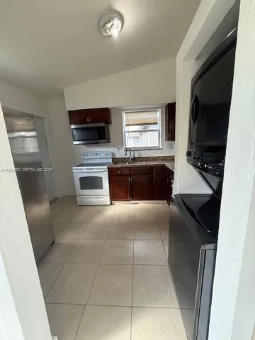 a kitchen with a sink and a stove top oven