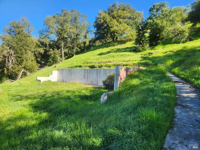 a view of a pathway of a building with a yard