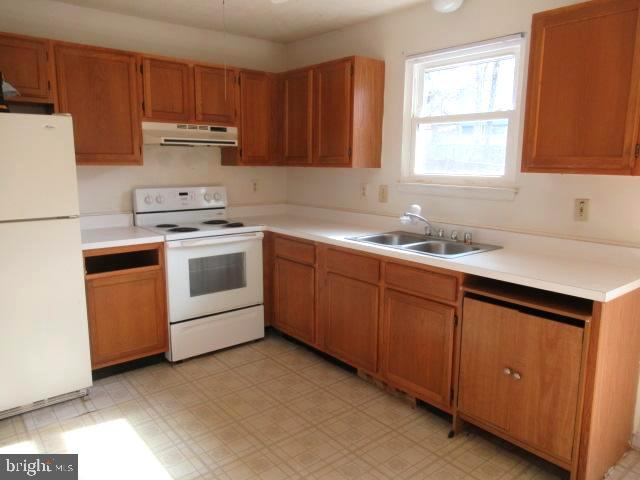 665 Flagstaff Road Lusby, MD 20657 - Photo 11 of 11 a kitchen with a sink stove and cabinets
