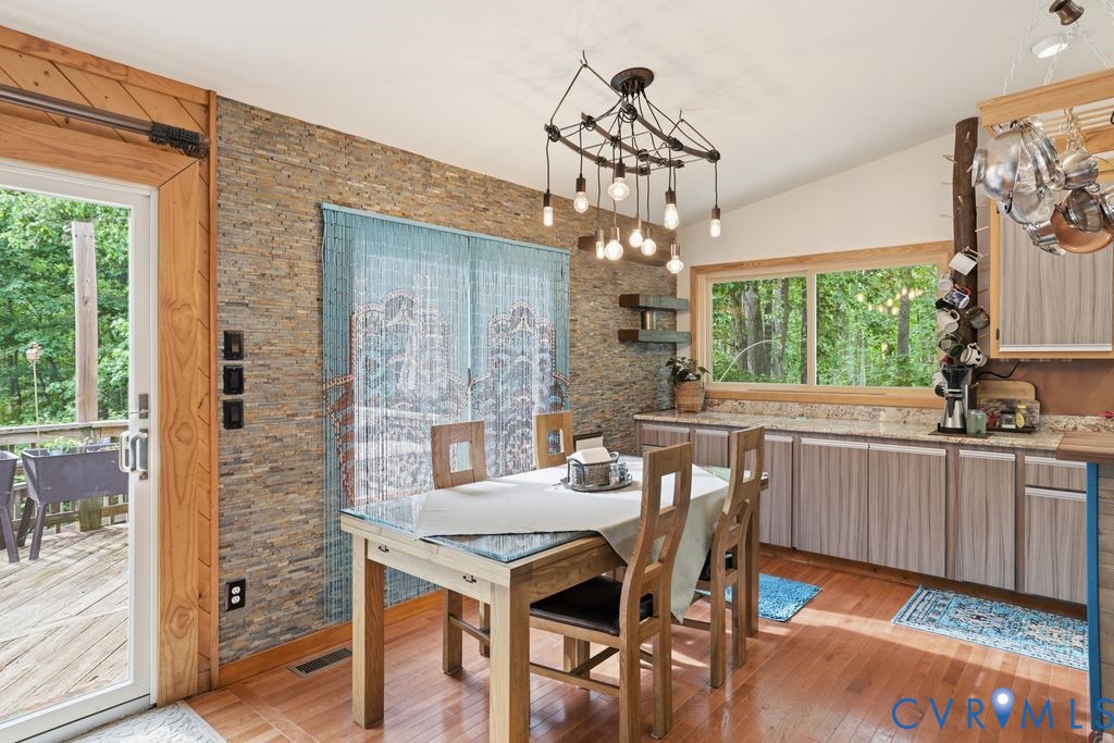 1061 Turkey Ridge Drive Moseley, VA 23120 - Photo 13 of 51 a view of a dining room with furniture a chandelier and wooden floor