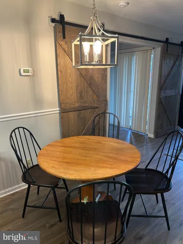 a dining room with a table chairs and a wooden floor
