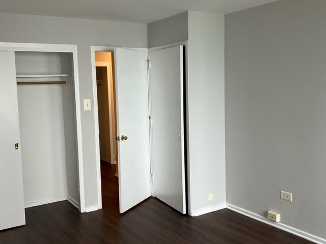 6030 North Sheridan Road, Unit 1712 Chicago, IL 60660 - Photo 18 of 28 a view of an empty room with wooden floor