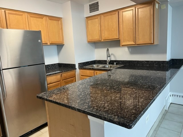 6030 North Sheridan Road, Unit 1712 Chicago, IL 60660 - Photo 3 of 28 a kitchen with stainless steel appliances granite countertop a sink refrigerator and microwave