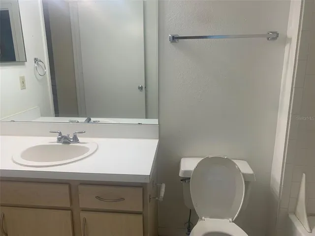 a white bath tub sitting next to a toilet