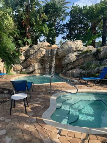a view of a swimming pool with a patio