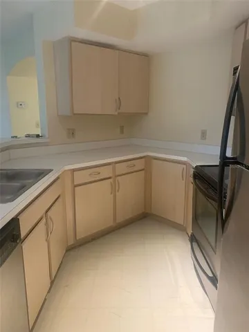 a kitchen with a sink and cabinets