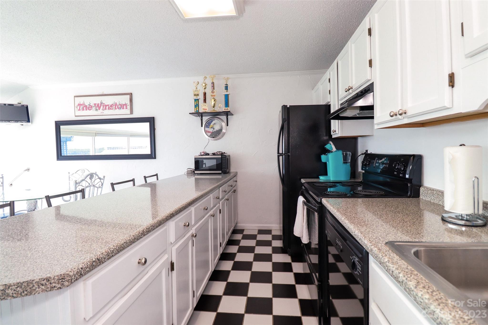 4721 Morehead Road, Unit 204 Concord, NC 28027 - Photo 12 of 19 a kitchen with stainless steel appliances granite countertop a sink stove and refrigerator