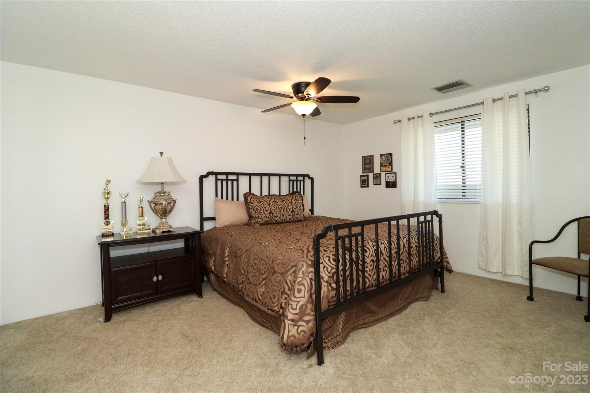 4721 Morehead Road, Unit 204 Concord, NC 28027 - Photo 13 of 19 a bedroom with a bed and a ceiling fan