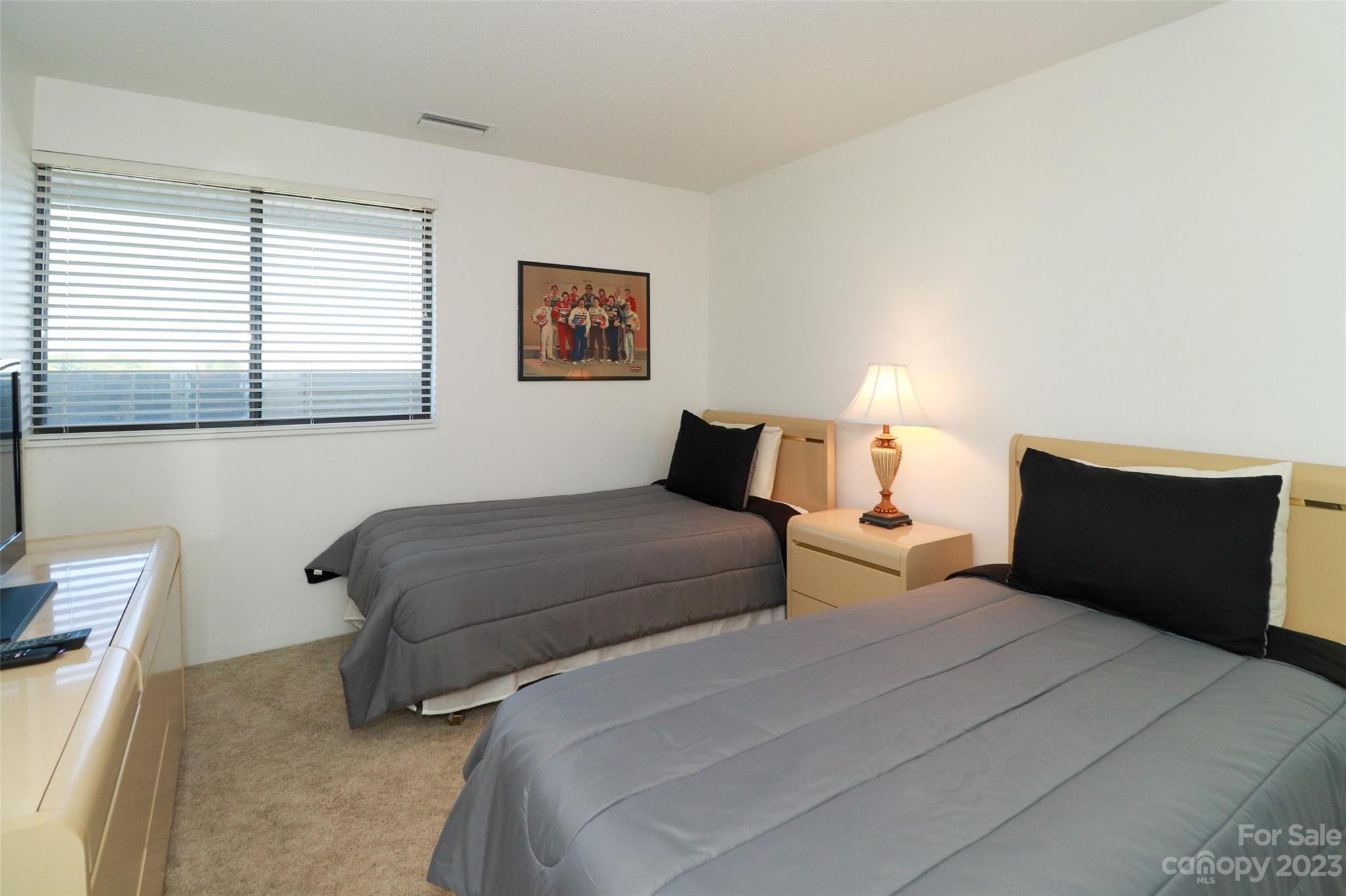 4721 Morehead Road, Unit 204 Concord, NC 28027 - Photo 16 of 19 a bedroom with a bed and a night stand