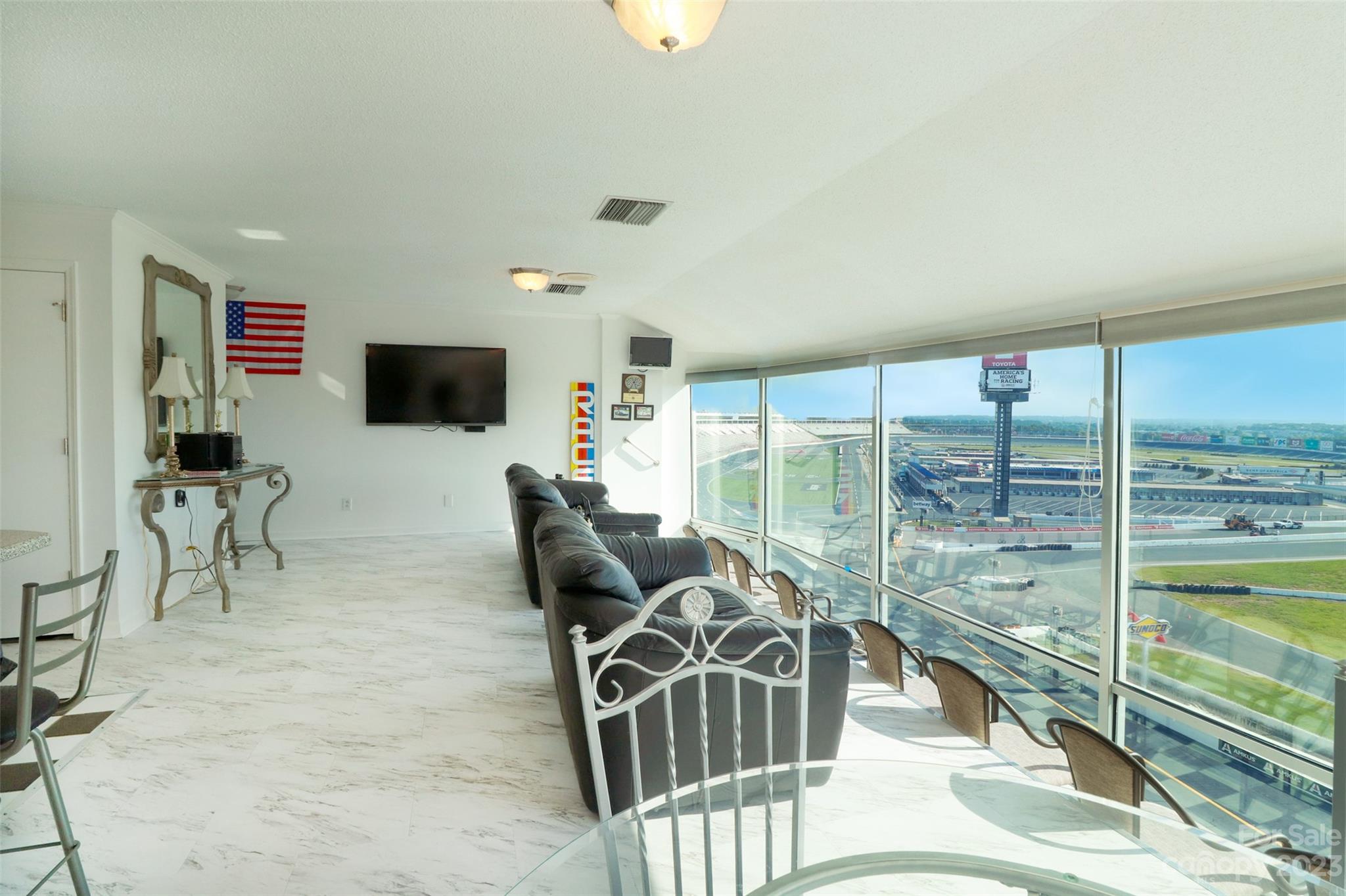4721 Morehead Road, Unit 204 Concord, NC 28027 - Photo 6 of 19 a living room with furniture floor to ceiling window and a flat screen tv