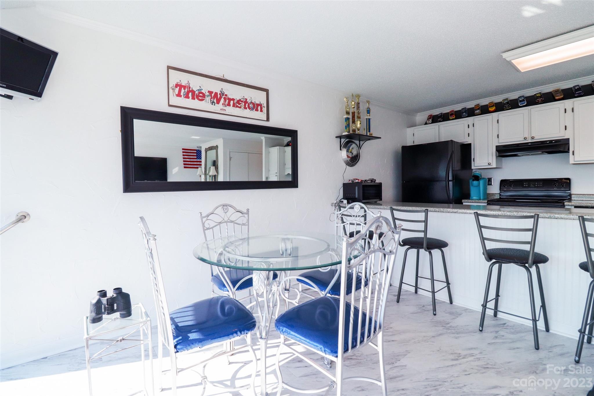 4721 Morehead Road, Unit 204 Concord, NC 28027 - Photo 10 of 19 a kitchen with stainless steel appliances kitchen island granite countertop a sink and a microwave