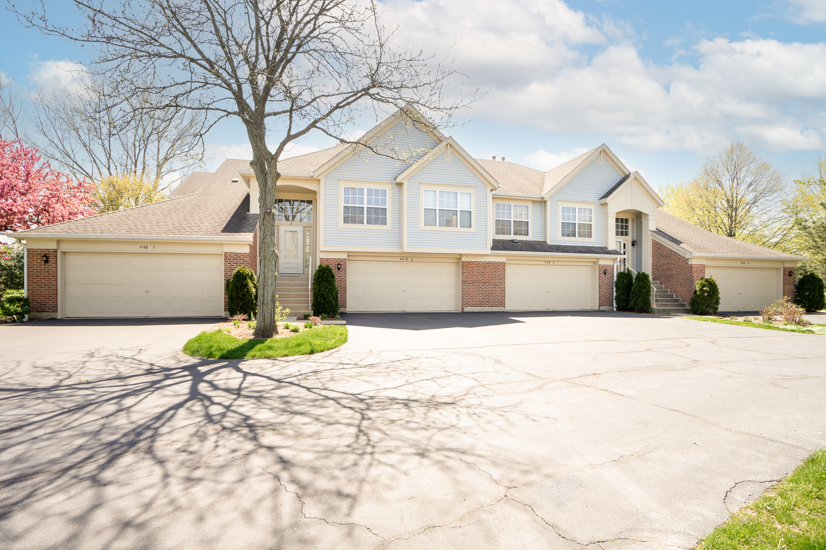 446 Cromwell Circle, Unit 1 Bartlett, IL 60103 - Photo 28 of 28 a front view of a house with a yard and garage