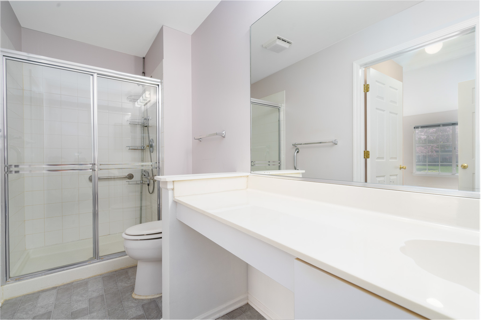 446 Cromwell Circle, Unit 1 Bartlett, IL 60103 - Photo 4 of 28 a spacious bathroom with a granite countertop sink a toilet and shower