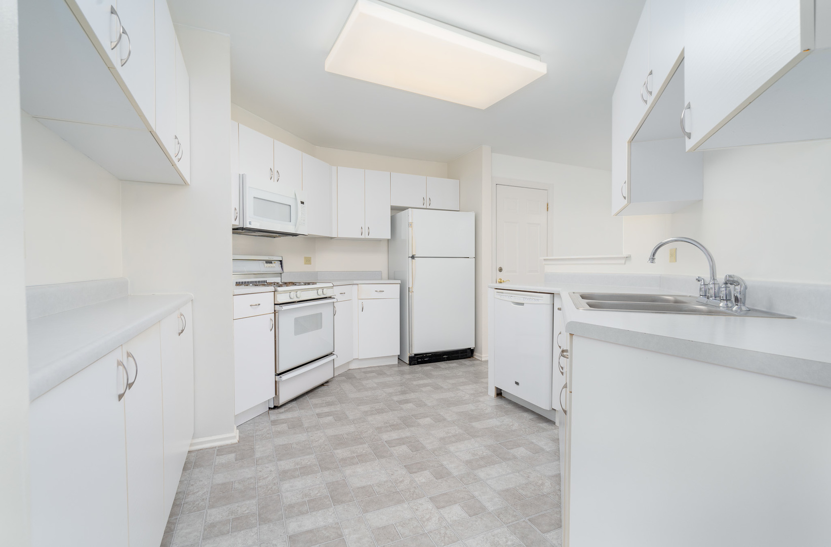446 Cromwell Circle, Unit 1 Bartlett, IL 60103 - Photo 8 of 28 a kitchen with white cabinets and white appliances