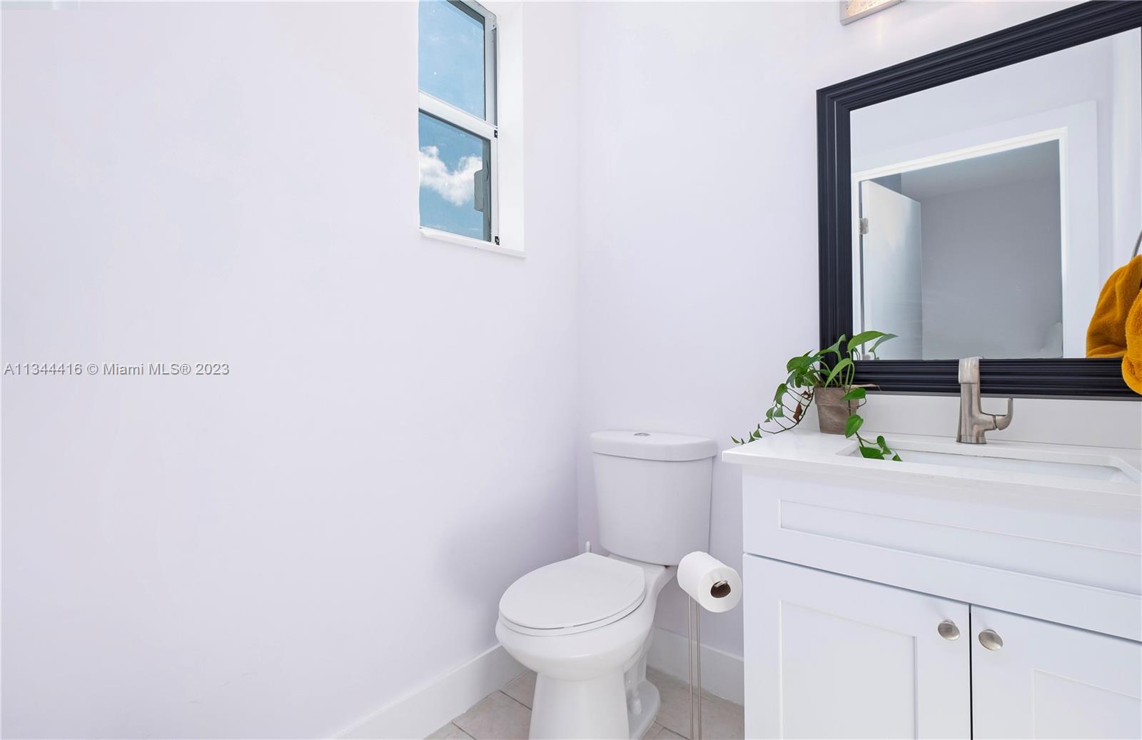 2734 Southwest 26th Street, Unit 2734 Miami, FL 33133 - Photo 12 of 41 a bathroom with a toilet sink and mirror