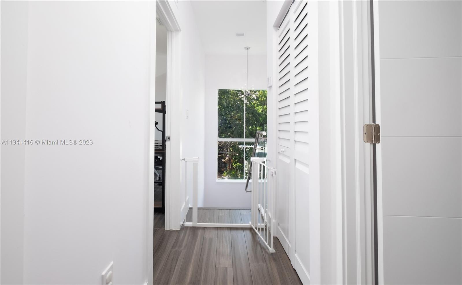 2734 Southwest 26th Street, Unit 2734 Miami, FL 33133 - Photo 13 of 41 a view of a hallway with wooden floor and a window