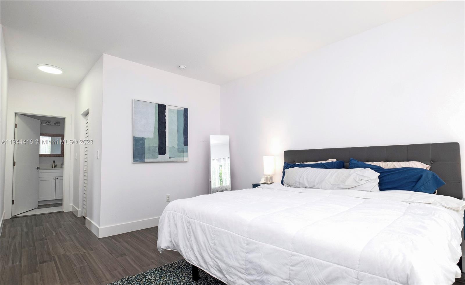 2734 Southwest 26th Street, Unit 2734 Miami, FL 33133 - Photo 14 of 41 a bedroom with a bed and wooden floor