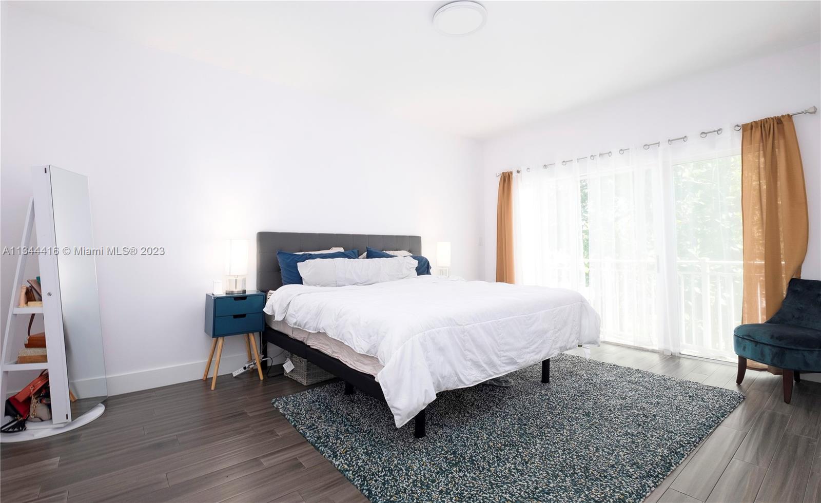 2734 Southwest 26th Street, Unit 2734 Miami, FL 33133 - Photo 15 of 41 a bedroom with a bed and a window
