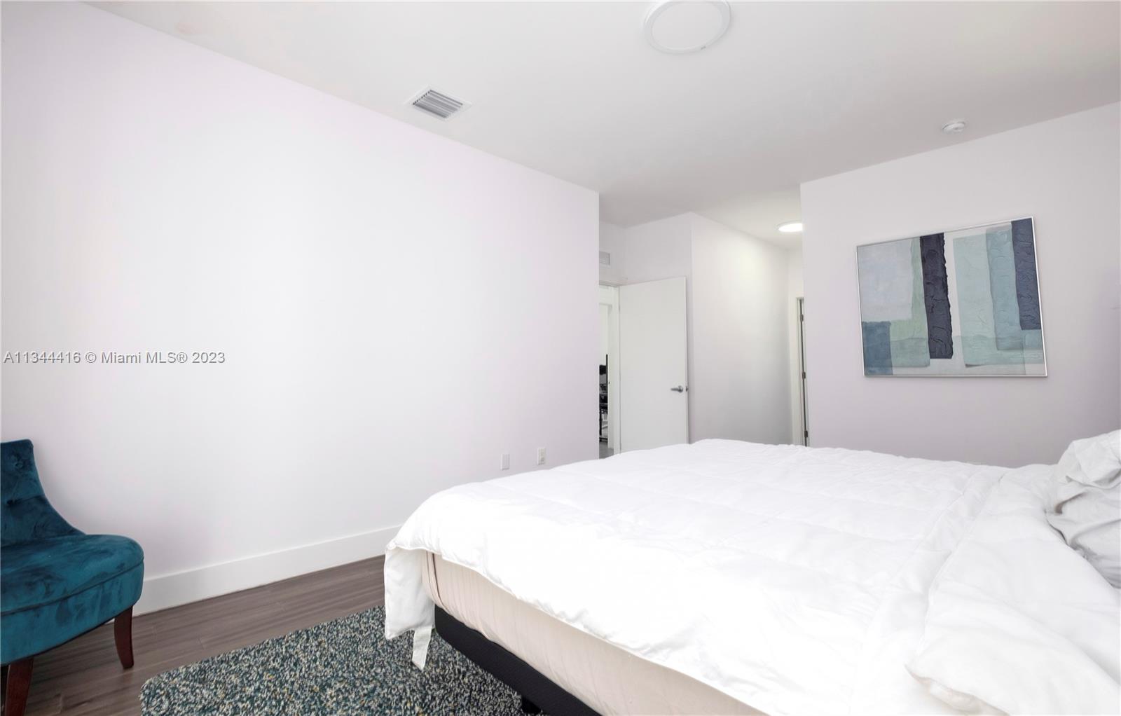 2734 Southwest 26th Street, Unit 2734 Miami, FL 33133 - Photo 16 of 41 a spacious bedroom with a bed and a window