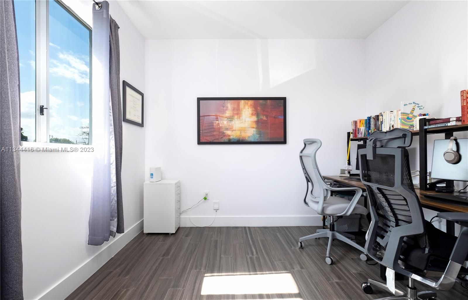 2734 Southwest 26th Street, Unit 2734 Miami, FL 33133 - Photo 19 of 41 a view of a workspace with wooden floor and a window