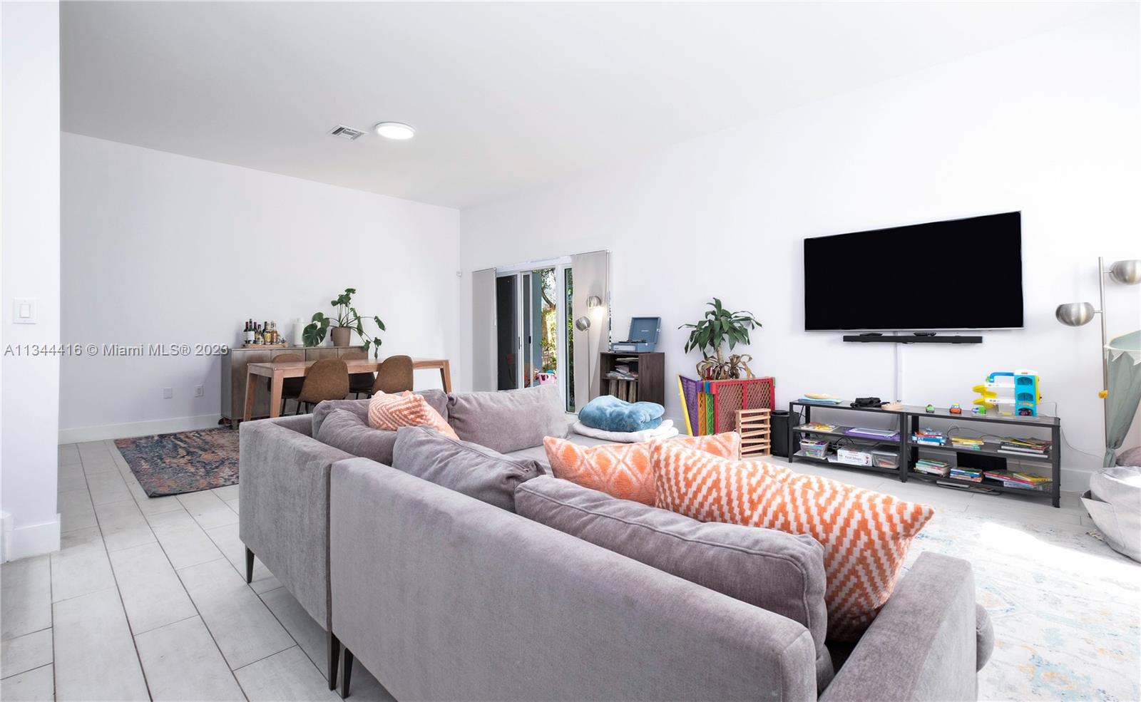 2734 Southwest 26th Street, Unit 2734 Miami, FL 33133 - Photo 2 of 41 a living room with furniture and a flat screen tv