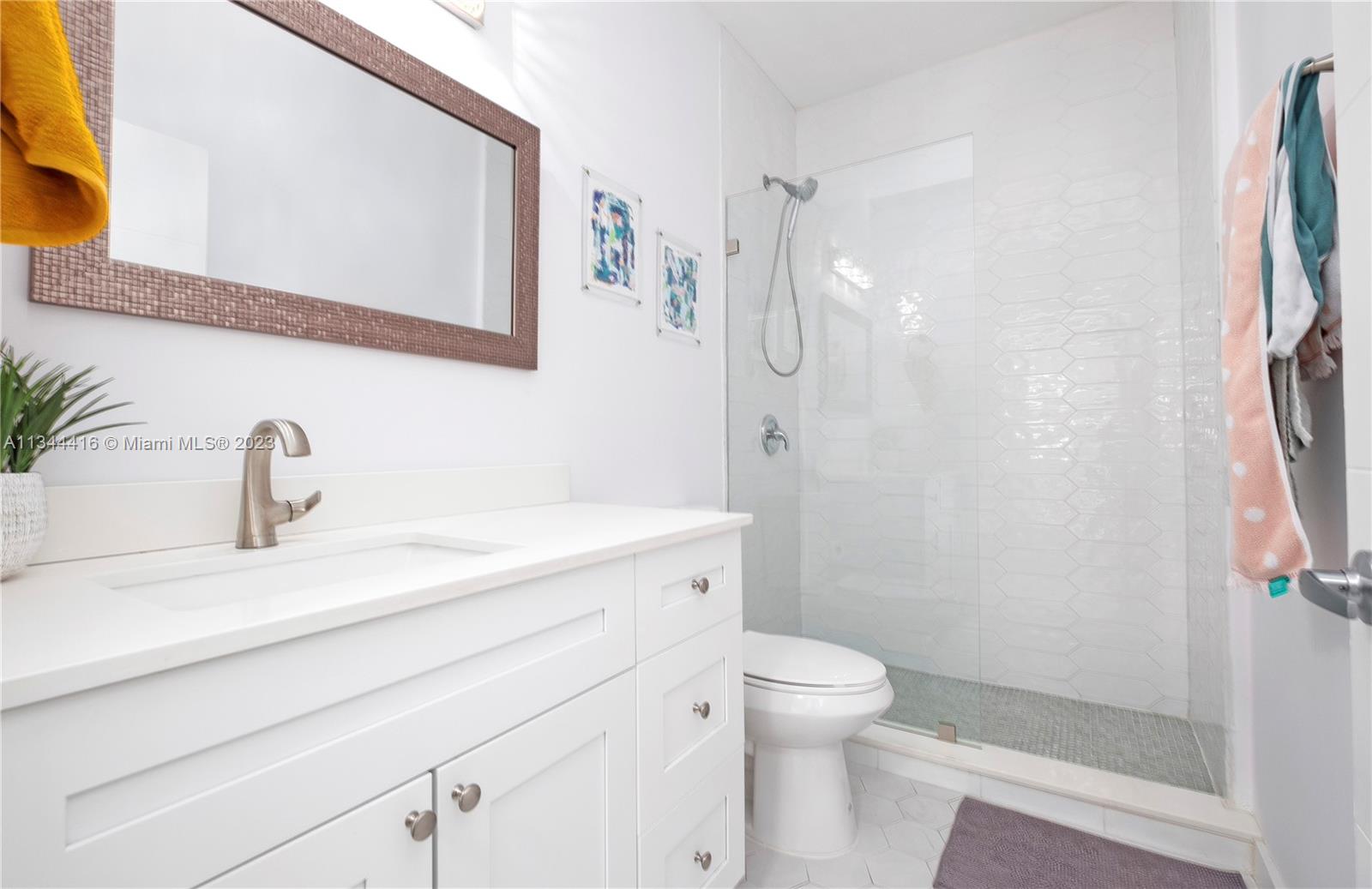 2734 Southwest 26th Street, Unit 2734 Miami, FL 33133 - Photo 23 of 41 a bathroom with a granite countertop sink toilet and shower