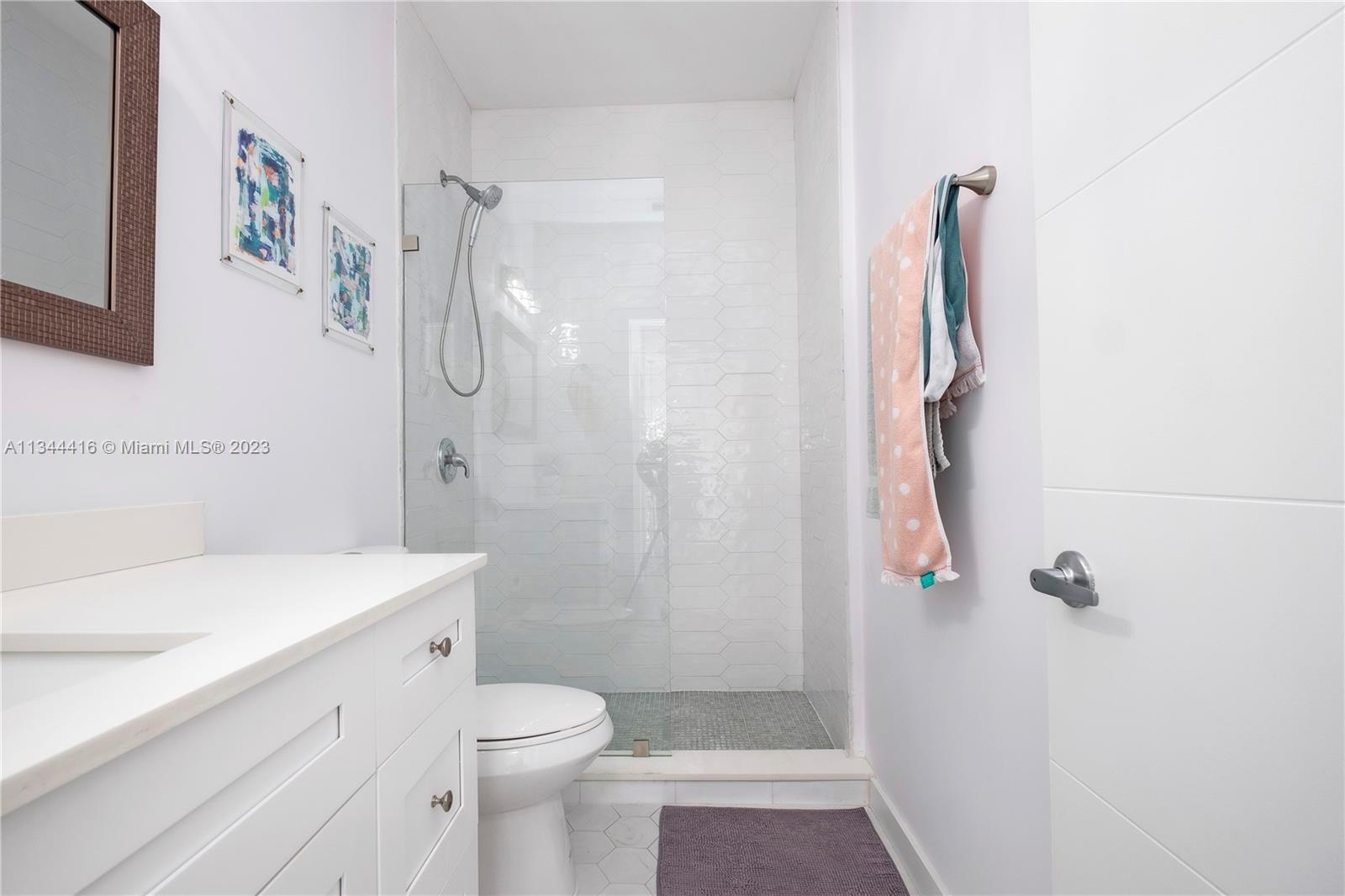 2734 Southwest 26th Street, Unit 2734 Miami, FL 33133 - Photo 24 of 41 a bathroom with a sink a toilet and shower