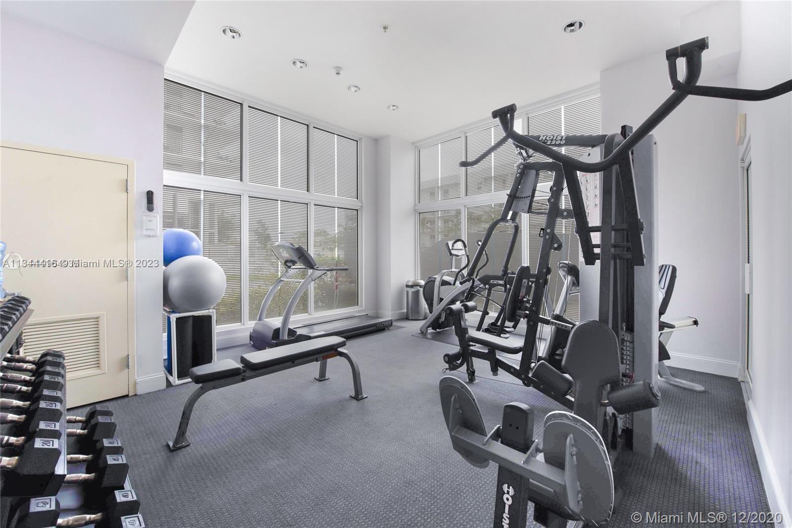 2734 Southwest 26th Street, Unit 2734 Miami, FL 33133 - Photo 30 of 41 a room with gym equipment and windows