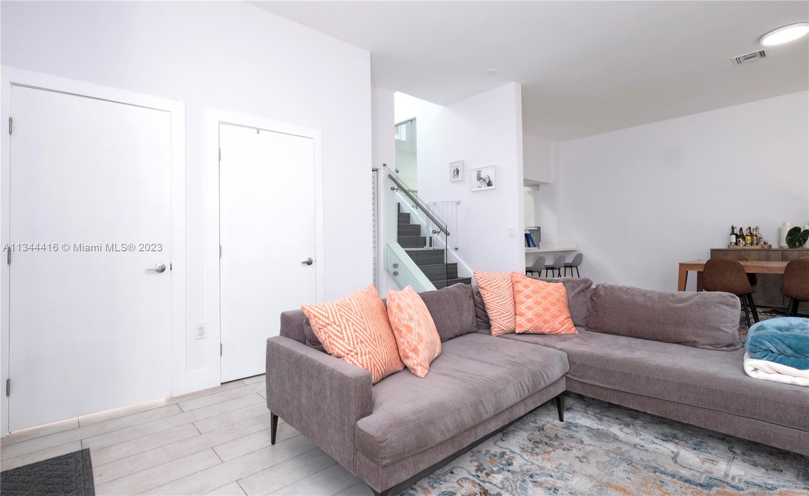 2734 Southwest 26th Street, Unit 2734 Miami, FL 33133 - Photo 4 of 41 a living room with furniture and a potted plant