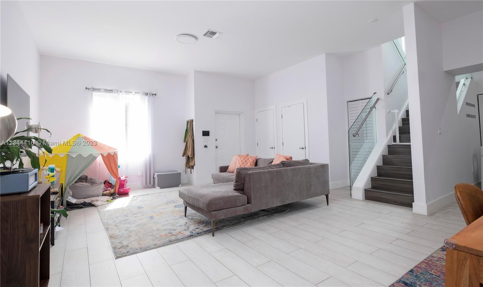 2734 Southwest 26th Street, Unit 2734 Miami, FL 33133 - Photo 5 of 41 a bedroom with furniture and stairs